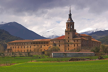 Snow topped mountain range, Sierra de la Demanda, behind a monastery, Monasterio de Yuso, San Millan de la Cogolla, La Rioja, Spain