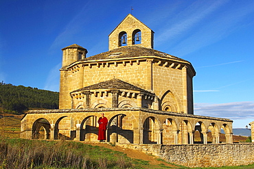 Pilgrim early in the morning in front of octagonal building, Santa MarÃŒa de Eunate, Camino de Santiago, Navarra, Spain