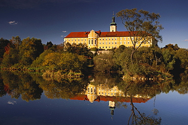 Calm waters of river Regen reflecting the former Cistercian abbey of Walderbach, Bavarian Forest, Upper Palatinate, Bavaria, Germany