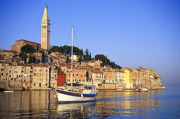 Sailing boat passing Old Town, Sv. Eufemija church, Rovinj, Istria, Croatia