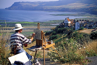 Man painting Robin Hood's Bay, North Yorkshire, England, United Kingdom