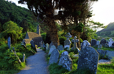 Old church and graveyard under some trees, Glendalough, Wicklow Mountains, County Wicklow, Ireland, Europe