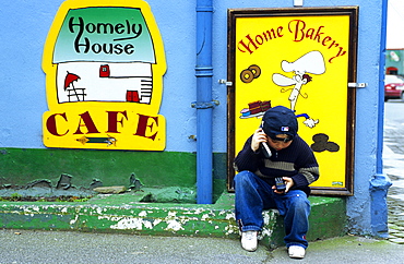 A boy phoning with a mobile phone, Dingle, County Kerry, Ireland, Europe