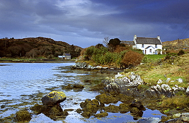 Cottage at Coulagh Bay under rain clouds, County Kerry, Ireland, Europe