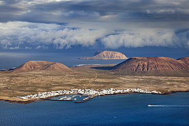 View of the island of La Graciosa under clouded sky, Lanzarote, Canary Islands, Spain, Europe