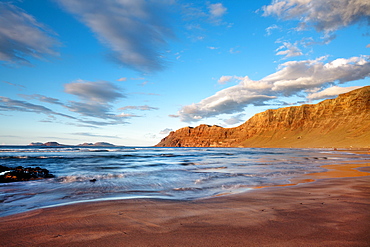 Beach Playa de Famara and mountain range Risco de Famara in the evening light, Lanzarote, Canary Islands, Spain, Europe