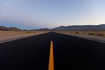 Moon above Death Valley Road and desert mountains, San Bernardino, California, USA, America