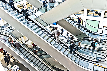 People, business people on escalators, Berlin Exhibition, Berlin, Germany