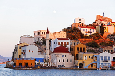 Faros-Coupa Bar, the mosque and the red castle at dusk, Kastelorizo Megiste, Dodecanese Islands, Greece, Europe