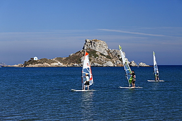 View from Agios Stefanos onto sailboarders in front of the peninsula of Kefalos, Kos, Dodecanese Islands, Greece, Europe