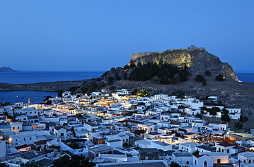 View over the roofs and onto the acropolis in the evening, Lindos, Rhodes, Dodecanese Islands, Greece, Europe