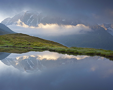 Mountain reflection in a mountain lake, View from Oberberg towards Hochfeiler (3510m), Pfitsch Valley, South Tirol, Italy