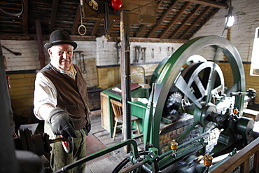 Volunteer explains steampowered flywheel to visitors, The Iron Gorge Museums, Blists Hill Victorian Town, Ironbridge Gorge, Telford, Shropshire, England, Great Britain, Europe