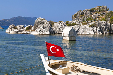 Boat with turkish flag, sarcophagus, Simena, Kalekoy, lycian coast, Mediterranean Sea, Turkey