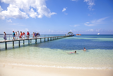 People on the pier at Punta Frances Parque Nacional with cruise ship MS Deutschland (Reederei Peter Deilmann) in the background, Isla de la Juventud, Cuba, Caribbean