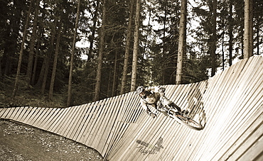 A teenager driving a ground loop on his mountain bike, Downhill Park, Wagrain, Austria