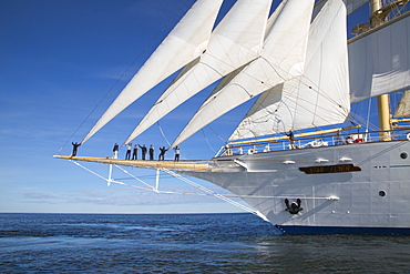 Captain Juergen Mueller-Cyran and sailors on bowsprit of sailing cruise ship Star Flyer under full sail, Baltic Sea, Finland, Europe