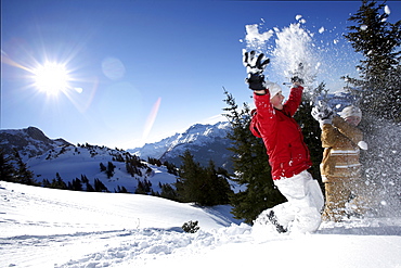 children throwing snow in the air, See, Tyrol, Austria