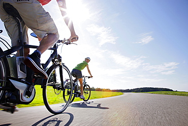 Young woman and young man on an e-bike, Lake Starnberg, Upper Bavaria, Germany