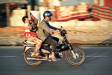 Vietnamese family riding on a motorbike, Mui Ne, Vietnam