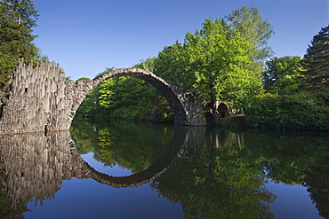 Rakotz bridge reflecting in lake Rakotzsee, Kromlau park, Kromlau, Saxony, Germany, Europe