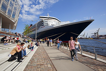 People in front of cruise ship Queen Mary 2 at harbour, Hamburg Cruise Center Hafen City, Hamburg, Germany, Europe