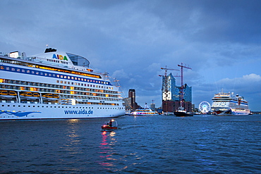 Cruise ships AIDAsol and AIDAblu clearing port in front of the Elbphilharmonie in the evening, Hamburg, Germany, Europe