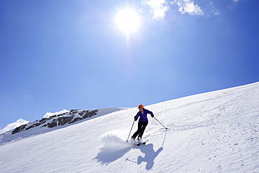 Woman backcountry skiing, descending on snow face, Schesaplana, Raetikon, Montafon, Vorarlberg, Austria