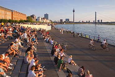 People sitting on the stairs to the Rhine river promenade, Duesseldorf, North Rhine-Westphalia, Germany, Europe