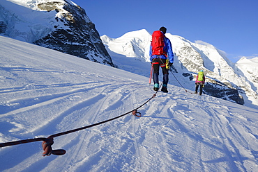 Roped party ascending on Cambrena glacier, ascent to Piz Palue, Grisons, Switzerland