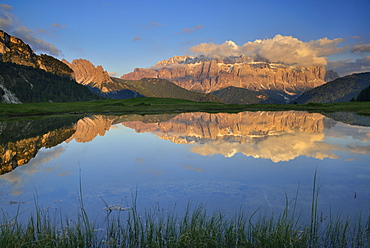 Sella range reflecting in a mountain lake, Val Gardena, Dolomites, UNESCO world heritage site Dolomites, South Tyrol, Italy