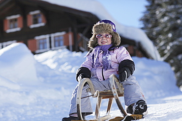 Girl (3 years) sledding, Gargellen, Montafon, Vorarlberg, Austria