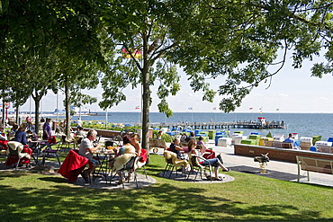 People at the promenade in the sunlight, Wyk, Foehr, North Frisian Islands, Schleswig-Holstein, Germany, Europe