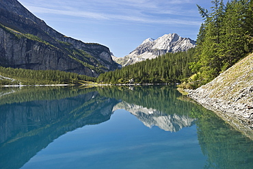 Reflection of mountains on lake Oeschinensee, Kandersteg, Bernese Oberland, Canton of Bern, Switzerland, Europe