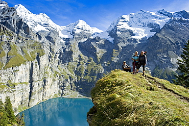 Hikers at lake Oeschinensee, Kandersteg, Bernese Oberland, Canton of Bern, Switzerland, Europe