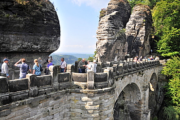 People on the stone bridge at the Bastei, Saxonien Switzerland, Saxony, Germany, Europe