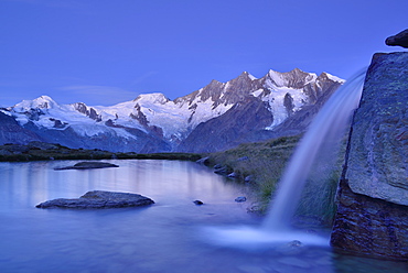 Mischabel range with Allalinhorn, Alphubel, Taeschhorn, Dom and Lenzspitze reflecting in a mountain lake, Pennine Alps, Valais, Switzerland