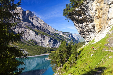 A man hiking at lake Oeschinen, Bernese Oberland, Canton of Bern, Switzerland