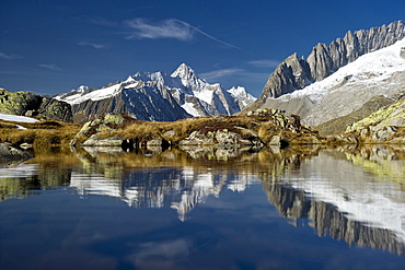 Reflection on lake Bettmersee, Bettmeralp, in the background Bernese Oberland, Canton of Valais, Switzerland, Europe