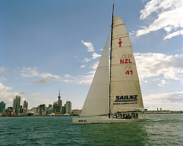 A sailing boat in front of the high rise buildings at Waitemata Harbour, Auckland, North Island, New Zealand