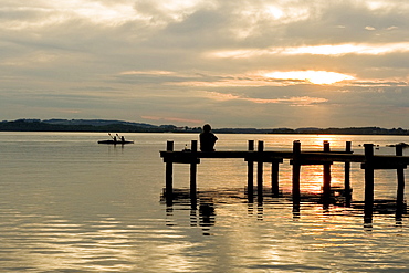 Jetty at sunset near Uebersee, Chiemsee, Chiemgau, Bavaria, Germany