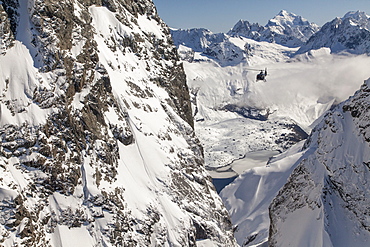 Helicopter flight through a ravine in snowy mountains, Southern Alps, South Island, New Zealand