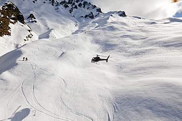 Helicopter landing with winter sportsmen, Skiers and snowboarders, Queenstown, South Island, New Zealand