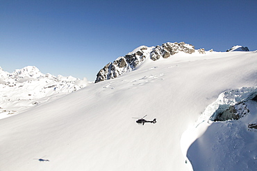 Helicopter flight over snowy mountains and the summits of the Southern Alps, South Island, New Zealand