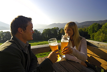 Young couple at a beer garden in the sunlight, lake Tegernsee, Bavaria, Germany, Europe