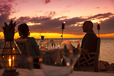 Dining couple at Restaurant DINING ROOM at sunset, Little Palm Island Resort, Florida Keys, USA