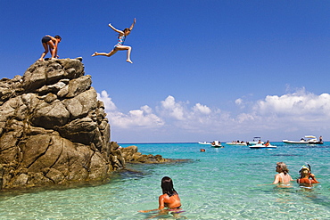 Children jumping off rocks into the sea, Marinella beach, Marina di Zambrone, Tyrrhenian Sea, Calabria, Mediterranean, Southern Italy, Europe