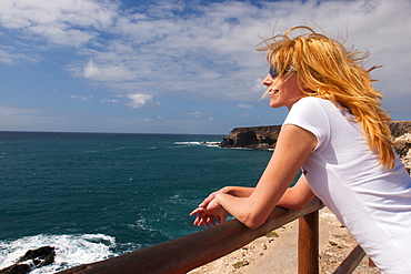 Young woman looking out to sea, Los Molinos, Fuerteventura, Canary Islands, Spain, Europe