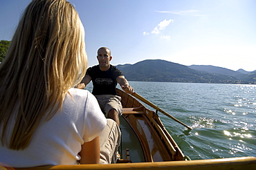 Couple in a rowing boat on Lake Tegernsee, Upper Bavaria, Bavaria, Germany