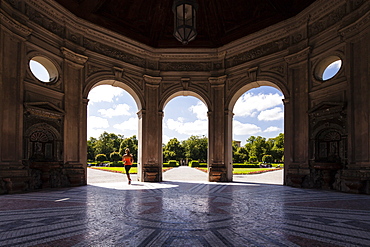 Young woman jogging through Dianatempel, Hofgarten, Munich, Bavaria, Germany